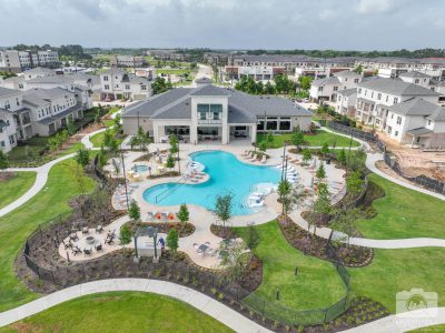 Aerial view of a community pool area with surrounding residential buildings.